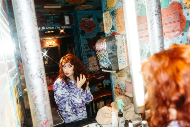 Chappell Roan photographed beside a mirror in a dressing room