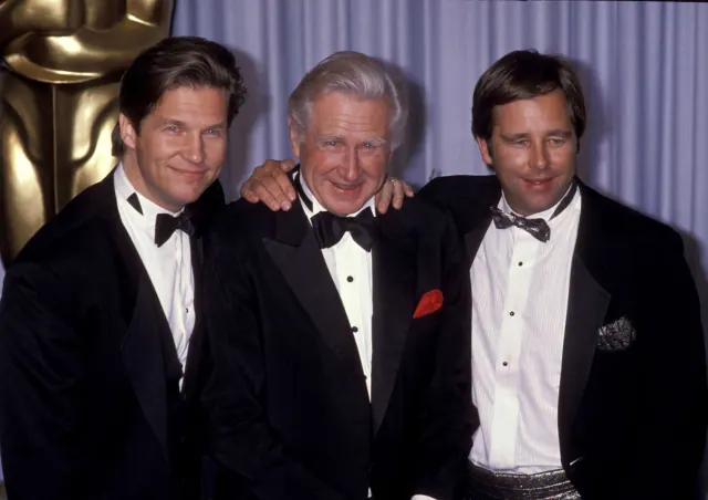 Jeff and Beau Bridges standing with their father Lloyd at a formal event