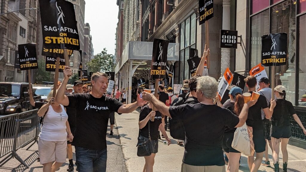 SAG-AFTRA members on strike outside of a movie studio in New York