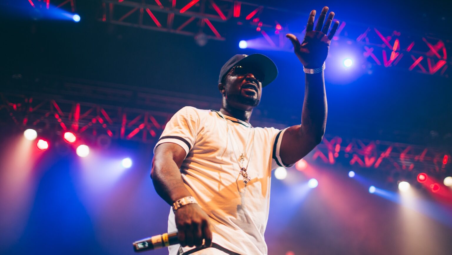 50 Cent preforming a rap show in a white t-shirt; 50 Cent Is Calling Everybody Out