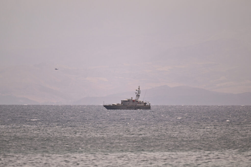 PORTICELLO, ITALY - AUGUST 19: A coast guard vessel searches for missing passengers after a yacht capsized on August 19, 2024 off the coast of Palermo, Italy. Several people, including four Britons, two Americans and a Canadian national, are missing after the 50-metre sailing yacht  Bayesian carrying 22 passengers sank of the coast of Porticello in the province of Palermo, Sicily, at around 03:00 GMT. Italy's coastguard and firefighters brought 15 people to safety with rescue and recovery efforts ongoing. (Photo by Vincenzo Pepe/Getty Images)