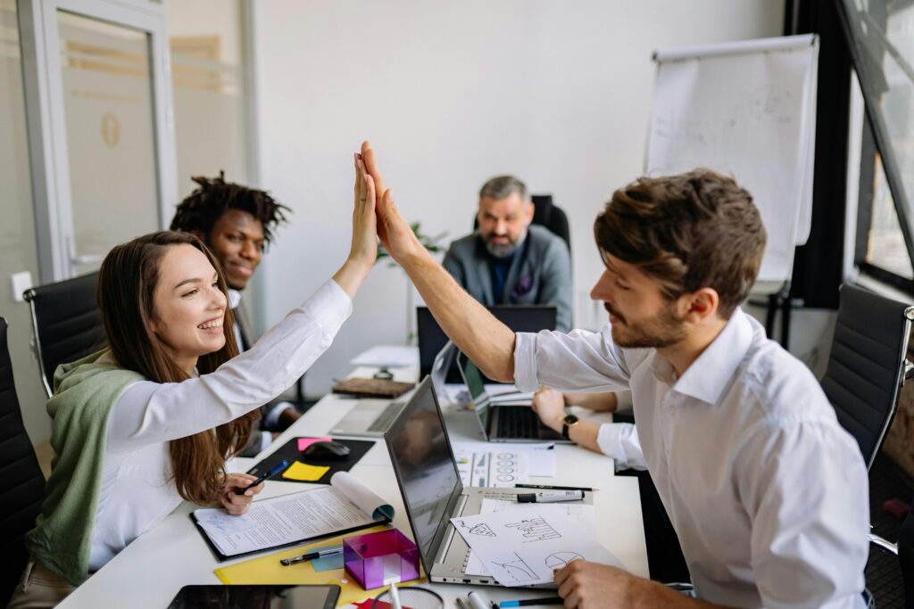 Man and Woman Doing High Five at the Meeting