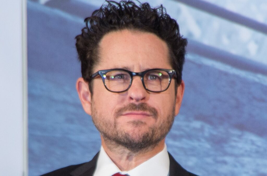 JJ Abrams in a white and black suit on a red carpet