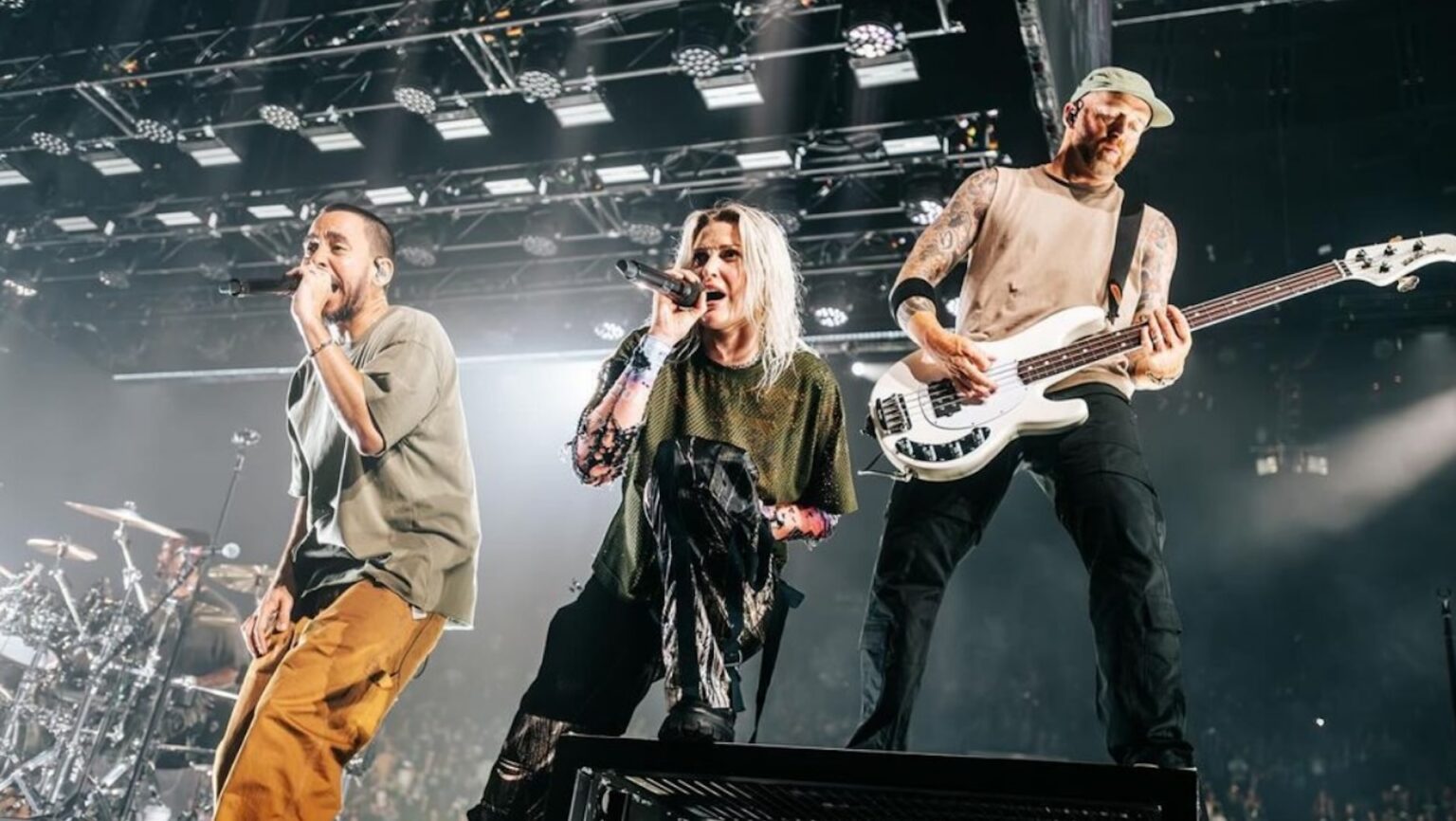 Linkin Park band members playing on a stage.