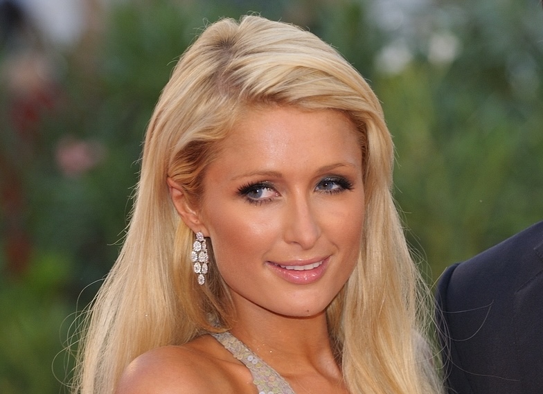 Paris Hilton in a silver dress on a red carpet