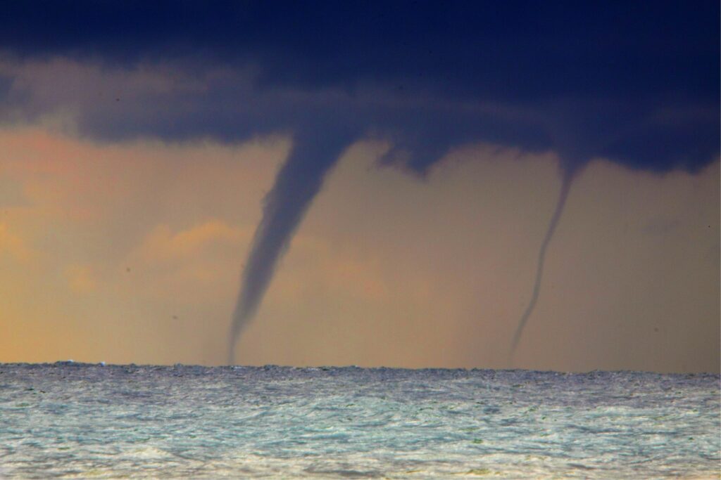 waterspout forming out over the sea