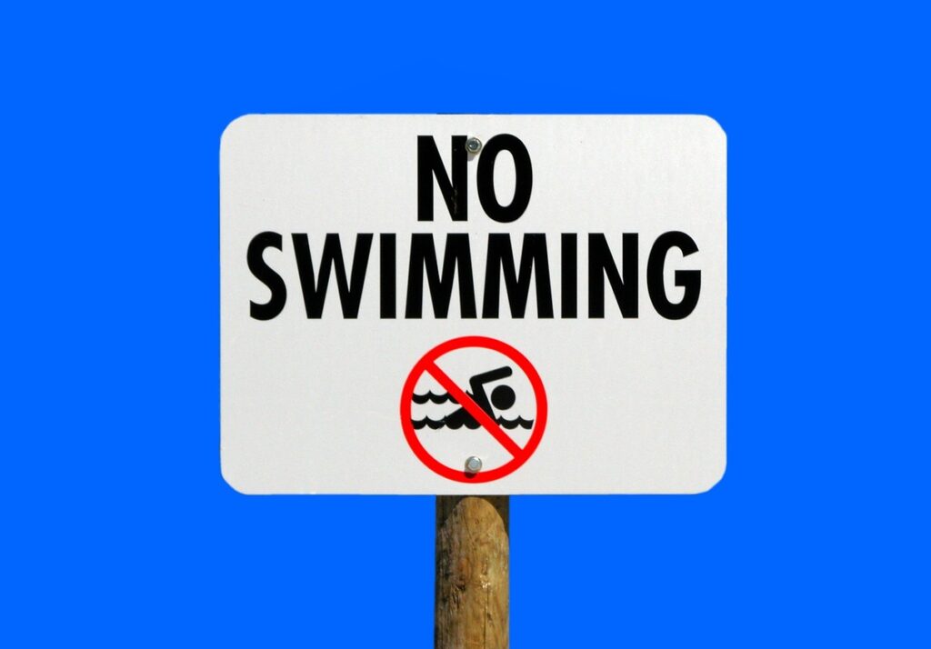 no swimming sign against blue background