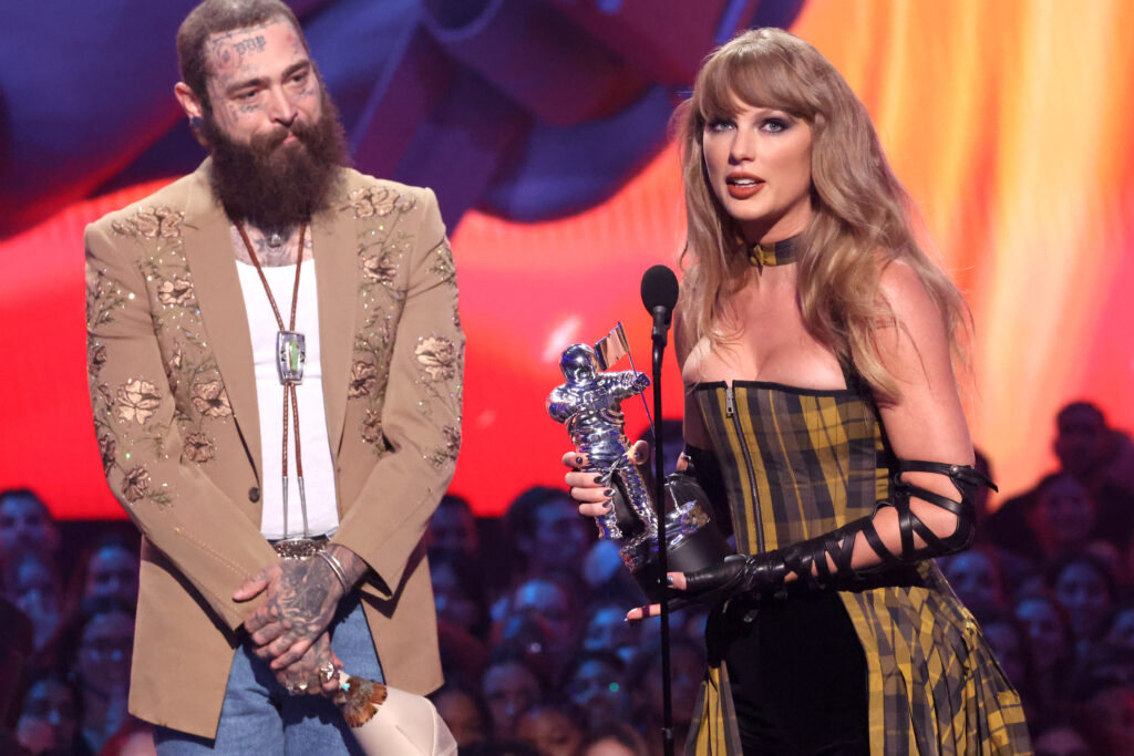 ELMONT, NEW YORK - SEPTEMBER 11: (L-R) Post Malone and Taylor Swift accept the Best Collaboration award for "Fortnight" on stage during the 2024 MTV Video Music Awards at UBS Arena on September 11, 2024 in Elmont, New York. (Photo by Mike Coppola/Getty Images for MTV)