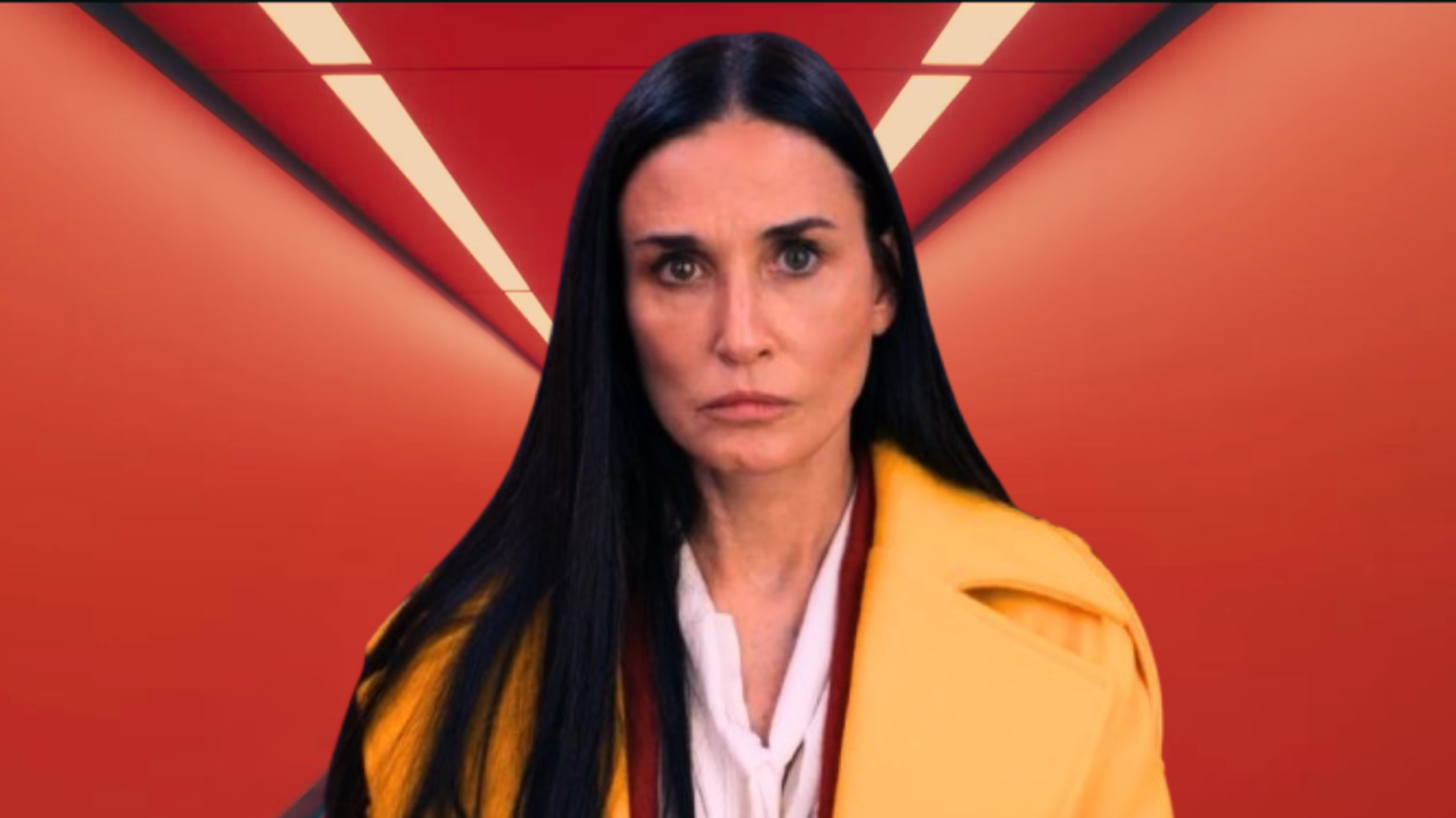 Demi Moore in 2024 The Substance looking in a mirror in a yellow jacket with a red wall, blue door in the background