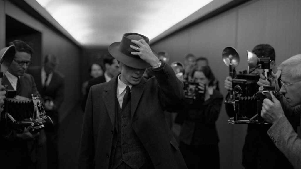 J. Robert Oppenheimer (Cillian Murphy) walking out of a meeting journalist waiting for him in 'Oppenheimer.'