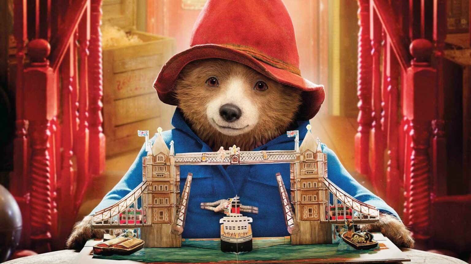 Paddington holding a picture book in 'Paddington 2'