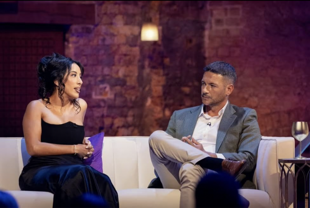 Scene from Love Blind, U.K. with Tom Stroud, Maria Benkh sitting on a couch at the reunion