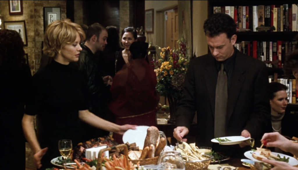 Tom Hanks and Meg Ryan loading up their plates at a lavish house party in 1998's You've Got Mail