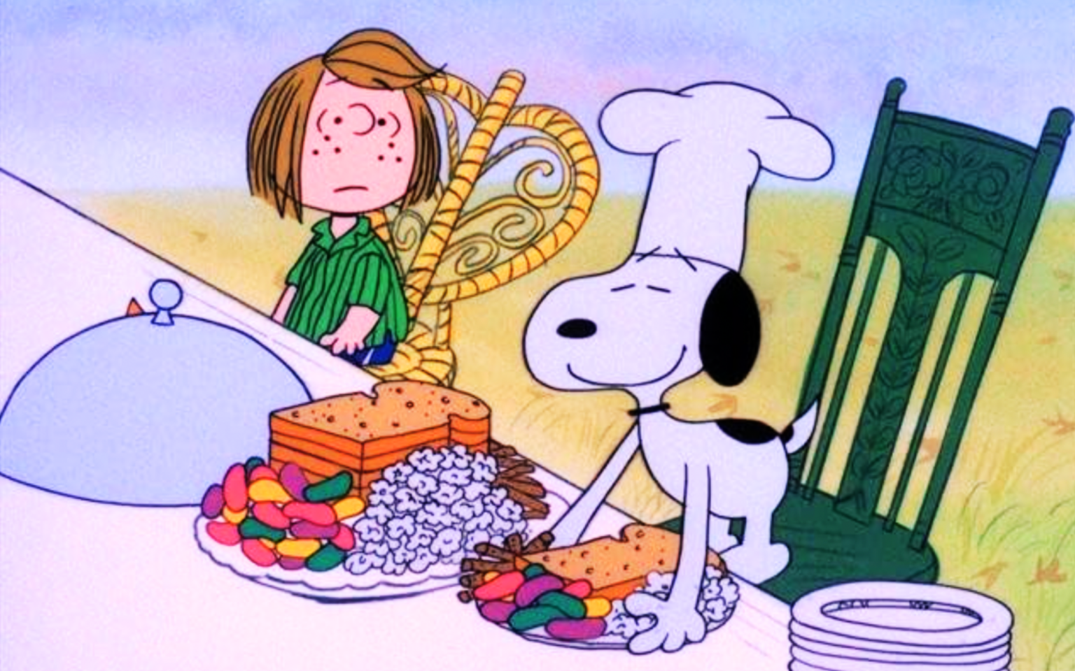 Snoopy setting a plate with a sandwich, jellybeans, and popcorn down on a table with a white cloth; 10 Movies to Watch This Thanksgiving.