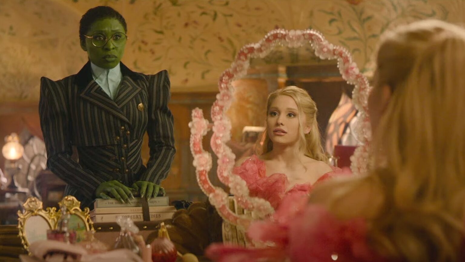 Elphaba (Cythia Ervio) looking at Galinda (Ariana Grande) in their shared dorm room in 'Wicked.'