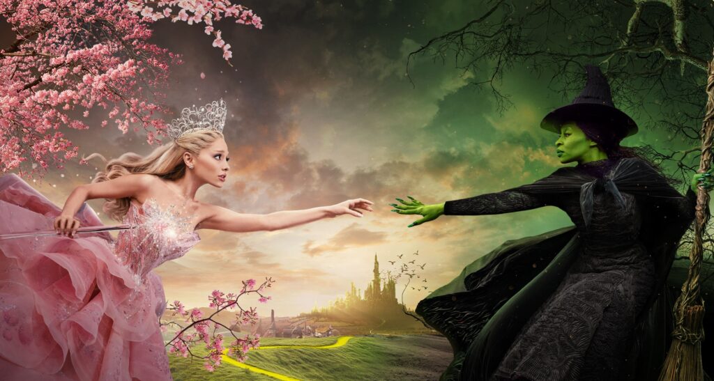 Elphaba (Cythia Ervio) reaching out her hand to Galinda (Ariana Grand) in 'Wicked.'